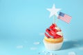 Tasty patriotic cupcake on color background