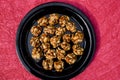 Tasty Peanut ladoo of small size sweet balls. Indian festival makarsankranti special item on red backgroud space to write text