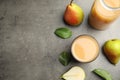 Tasty pear juice, fruits and leaves on table, flat lay. Space for text Royalty Free Stock Photo