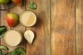 Tasty pear juice, fruits and leaves on wooden table, flat lay. Space for text Royalty Free Stock Photo