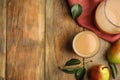 Tasty pear juice, fruits and leaves on wooden table, flat lay. Space for text Royalty Free Stock Photo