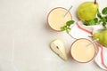 Tasty pear juice with mint and fruits on light grey marble table, flat lay. Space for text Royalty Free Stock Photo