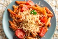 Tasty penne pasta with tomato sauce and grated cheese on plate, closeup Royalty Free Stock Photo