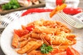 Tasty penne pasta with tomato sauce and grated cheese on plate, closeup Royalty Free Stock Photo