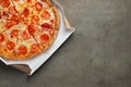 Tasty pepperoni pizza in a box on brown concrete background. Top view of hot pepperoni pizza. With copy space for text. Flat lay Royalty Free Stock Photo