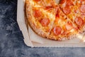 Tasty pepperoni pizza in a box on brown concrete background. Top view of hot pepperoni pizza. With copy space for text. Flat lay Royalty Free Stock Photo