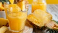Tasty pineapple juice in glass with pineapple fruit slices. Fresh natural pineapple cocktail and juice in glass on white Royalty Free Stock Photo