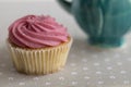 Pink cupcake on gray background. Royalty Free Stock Photo