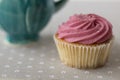 Pink cupcake on gray background. Royalty Free Stock Photo