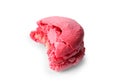 Tasty pink macaron with bite mark on white background