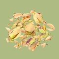 Tasty pistachios with cracked nut shells in air on color background Royalty Free Stock Photo