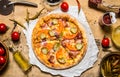 Tasty pizza with bacon and tomatoes. On wooden table. Royalty Free Stock Photo