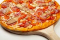 Tasty pizza Spicy pepper served on a wooden plate, ingredients Signature sauce, mozzarella cheese, pepperoni, pickled Royalty Free Stock Photo