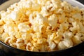 Tasty popcorn with cheese cheddar and parmesan in a bowl macro.