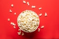 Tasty popcorn in a paper cup on a red background, top view Royalty Free Stock Photo