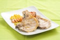 Tasty pork chop with corn carrot tomato Royalty Free Stock Photo