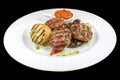 Tasty pork meatballs with Ljutenica, potato, and spices on a plate,