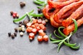 Tasty pork sausages with spices and rosemary leaves Royalty Free Stock Photo