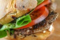 Tasty pork steak sandwich in a ciabatta with tomatos, lettuce Royalty Free Stock Photo