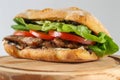 Tasty pork steak sandwich in a ciabatta with tomatos, lettuce