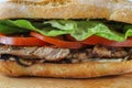 Tasty pork steak sandwich in a ciabatta with tomatos, lettuce Royalty Free Stock Photo