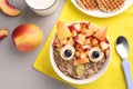Tasty porridge served with fruits, milk and waffles on table, flat lay. Creative idea for kids breakfast