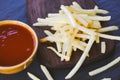 Tasty potato fries for food or snack delicious Italian meny homemade ingredients - french fries ketchup in wooden board with black
