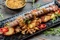 Tasty potatoes and sausages wedges are served with chili peppers and mustard, Food recipe background. Close up Royalty Free Stock Photo