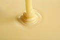 Tasty pouring condensed milk as background. Dairy product Royalty Free Stock Photo