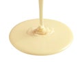 Tasty pouring condensed milk on white background