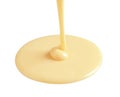 Tasty pouring condensed milk on white background.