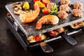 Tasty prawn tails cooking on a raclette grill Royalty Free Stock Photo