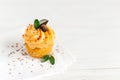 Tasty pumpkin cupcake with orange cream and decoration on white wooden table. Place for text Royalty Free Stock Photo