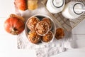 Tasty pumpkin muffins with sunflower seeds and bottles of milk on white table Royalty Free Stock Photo