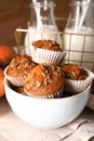 Tasty pumpkin muffins with sunflower seeds in bowl on table Royalty Free Stock Photo