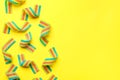 Tasty rainbow sour belts on yellow background, top view. Space for text Royalty Free Stock Photo
