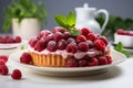 Tasty raspberry tart with cream and white dishes on gray background. Copy space