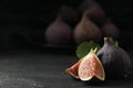 Tasty raw figs on black slate table, closeup. Space for text Royalty Free Stock Photo