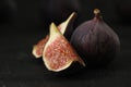Tasty raw figs on black slate table Royalty Free Stock Photo