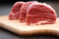 Tasty raw beef meat on wooden cutting board