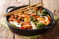 Tasty recipe for stir fry seafood with fresh vegetables close-up in a pan. horizontal Royalty Free Stock Photo