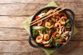 Tasty recipe for stir fry seafood with fresh vegetables close-up in a pan. horizontal top view Royalty Free Stock Photo