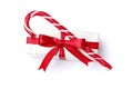 Tasty red candy cane and gift isolated on white background.