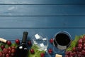 Tasty red wine and grapes on blue wooden table, flat lay. Space for text Royalty Free Stock Photo