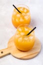 Tasty and Refreshing Orange Juice in Glass with Black Straws on Light Gray Background Fresh Ripe Oranges Wooden Tray Vertical Royalty Free Stock Photo