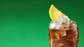 Tasty refreshing soda drink with ice cubes and lemon slice on green background, closeup. Banner design with space for text Royalty Free Stock Photo