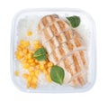 Tasty rice with grilled meat and corn in plastic container isolated on white, top view Royalty Free Stock Photo