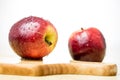 Tasty and ripe apples. Fruit sprinkled with water on a wooden kitchen table. Royalty Free Stock Photo