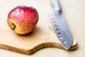 Tasty and ripe apples. Fruit sprinkled with water on a wooden kitchen table. Royalty Free Stock Photo