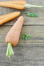 Tasty ripe carrots and cut on wooden table Royalty Free Stock Photo